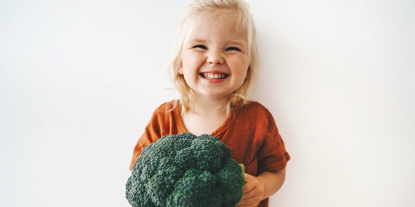 child wants to be a vegetarian holding a broccoli